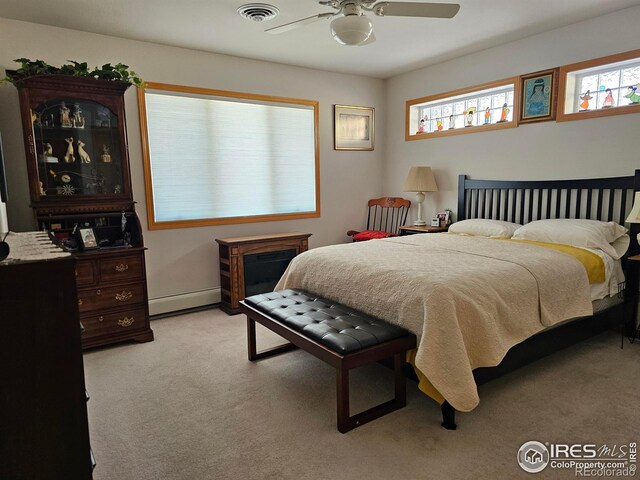 107 Fairway Ln, Fort Morgan, CO 80701 - bedroom featuring light carpet, baseboard heating, ceiling fan, and baseboards
