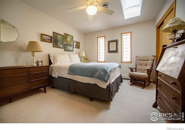 107 Fairway Ln, Fort Morgan, CO 80701 - carpeted bedroom featuring a skylight, a baseboard heating unit, a ceiling fan, and baseboards