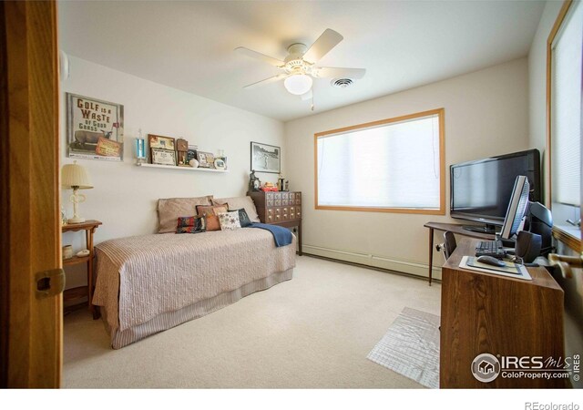 107 Fairway Ln, Fort Morgan, CO 80701 - bedroom with baseboard heating, carpet floors, ceiling fan, and a desk