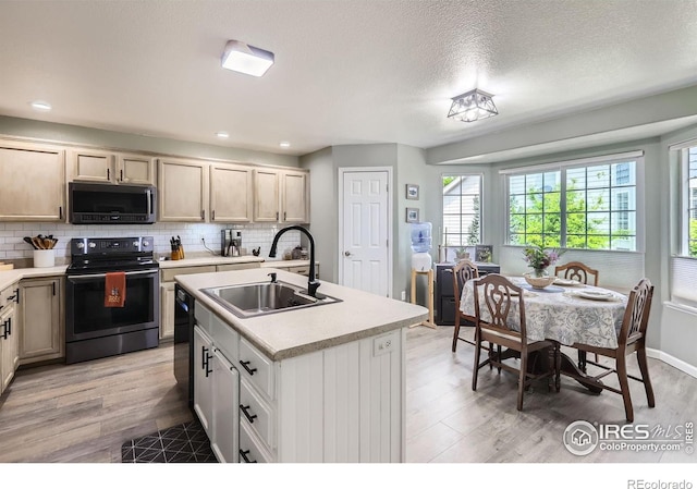 39 Sebring Ln, Johnstown, CO 80534 - kitchen featuring electric range oven, a sink, plenty of natural light, light countertops, and recessed lighting