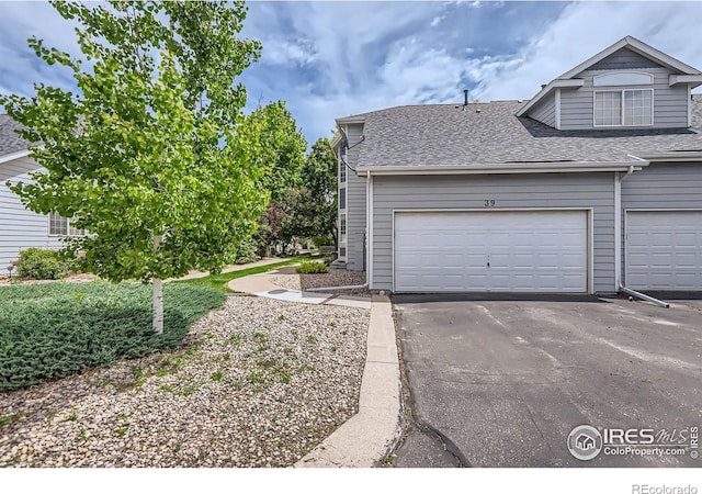 39 Sebring Ln, Johnstown, CO 80534 - view of home's exterior featuring roof with shingles and driveway