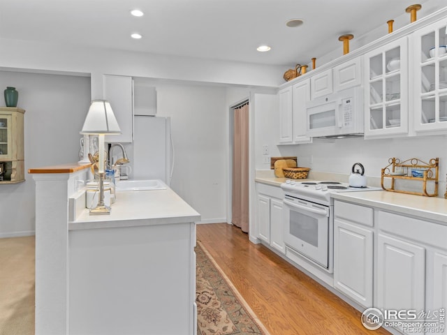 160 Riverside Dr Unit 2, Estes Park, CO 80517 - kitchen with white appliances, a sink, white cabinetry, glass insert cabinets, and recessed lighting