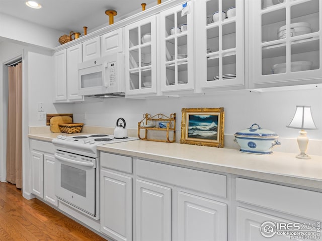 160 Riverside Dr Unit 2, Estes Park, CO 80517 - kitchen with white appliances, white cabinetry, light countertops, glass insert cabinets, and light wood-style floors
