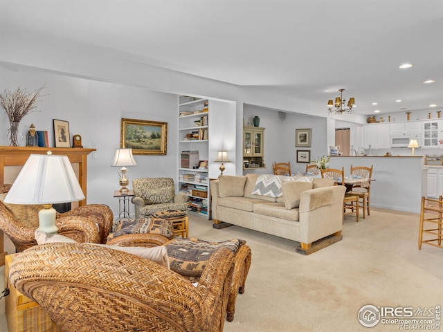 160 Riverside Dr Unit 2, Estes Park, CO 80517 - living area featuring a chandelier, light colored carpet, recessed lighting, and built in shelves