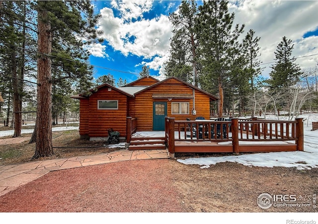 6 Norske Trl, Allenspark, CO 80510 - back of property featuring log veneer siding, a deck, and fence
