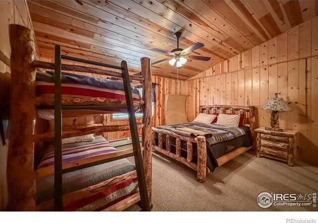 6 Norske Trl, Allenspark, CO 80510 - bedroom featuring lofted ceiling, carpet, wood ceiling, wood walls, and a baseboard radiator