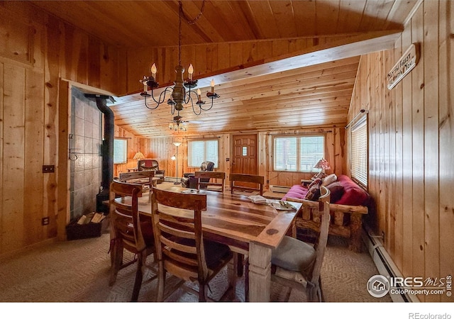 6 Norske Trl, Allenspark, CO 80510 - dining room featuring wood walls, a chandelier, carpet, baseboard heating, and a wood stove