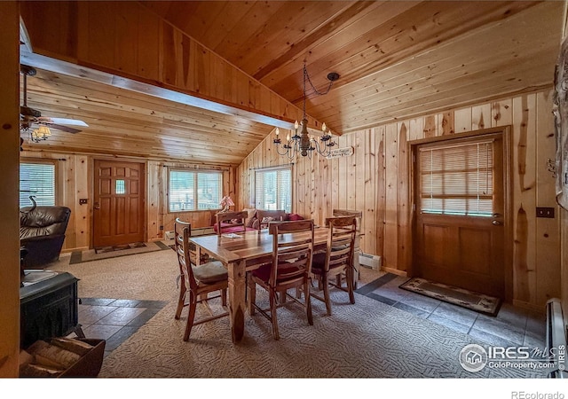 6 Norske Trl, Allenspark, CO 80510 - dining room featuring lofted ceiling, a wood stove, a chandelier, a baseboard heating unit, and wood walls