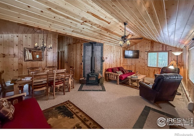 6 Norske Trl, Allenspark, CO 80510 - carpeted living room with a wood stove, vaulted ceiling, wood walls, wood ceiling, and a chandelier