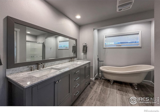 6 Norske Trl, Allenspark, CO 80510 - full bath with wood finished floors, baseboards, double vanity, a freestanding tub, and an enclosed shower