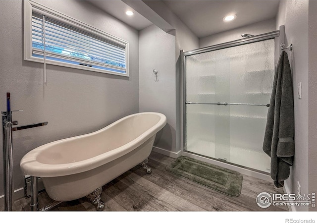 6 Norske Trl, Allenspark, CO 80510 - full bath with wood finished floors, a stall shower, a freestanding tub, and recessed lighting