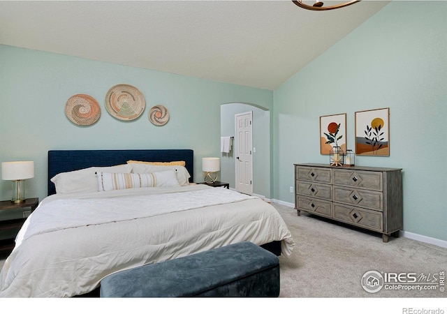 bedroom featuring baseboards, carpet, arched walkways, and high vaulted ceiling