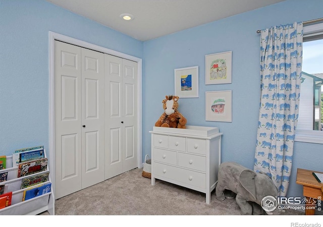 bedroom with carpet floors, a closet, and multiple windows