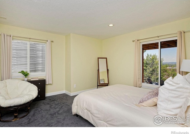 bedroom featuring dark carpet, a textured ceiling, recessed lighting, and baseboards