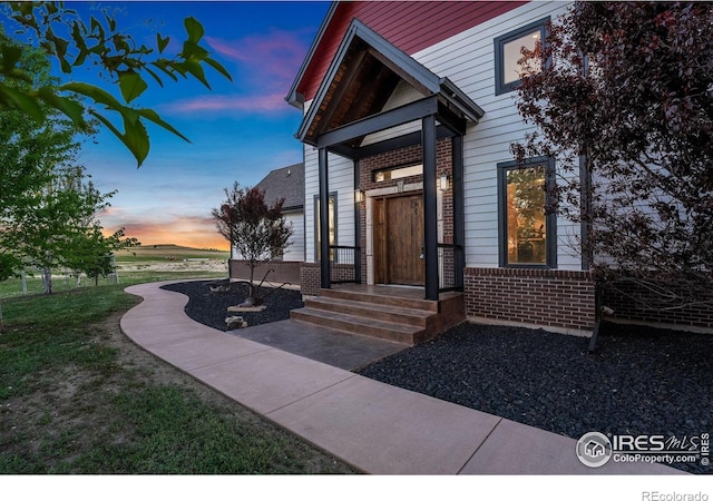 6950 W County Road 18, Loveland, CO 80537 - doorway to property featuring brick siding