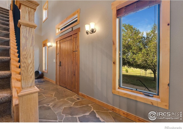 6950 W County Road 18, Loveland, CO 80537 - foyer with plenty of natural light, baseboards, and stairway