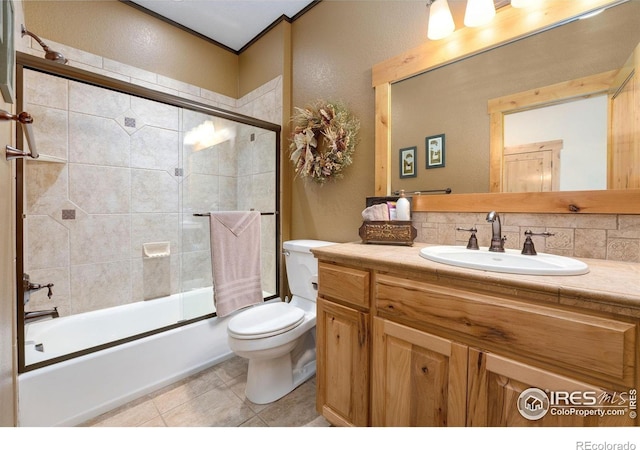6950 W County Road 18, Loveland, CO 80537 - full bath featuring a textured wall, toilet, enclosed tub / shower combo, tile patterned flooring, and vanity