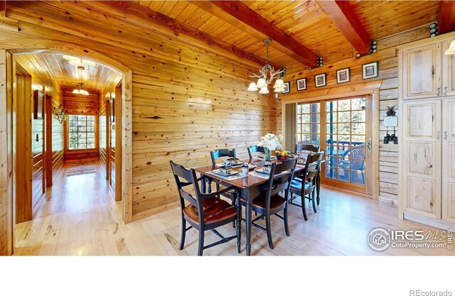 315 County Road 4454, Grand Lake, CO 80447 - dining space with a chandelier, wood walls, light wood-type flooring, beamed ceiling, and wooden ceiling