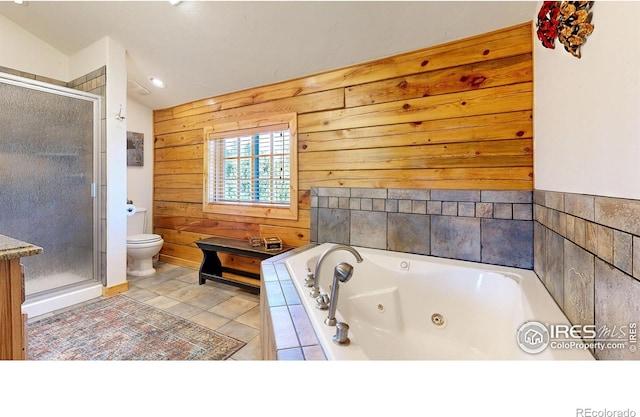315 County Road 4454, Grand Lake, CO 80447 - full bathroom featuring wood walls, a stall shower, toilet, and a tub with jets