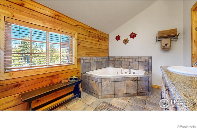 315 County Road 4454, Grand Lake, CO 80447 - bathroom with lofted ceiling, wooden walls, a bath, vanity, and tile patterned flooring