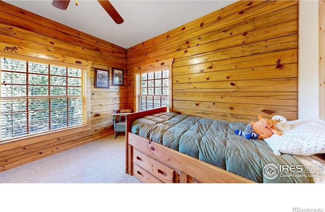 315 County Road 4454, Grand Lake, CO 80447 - carpeted bedroom featuring wood walls and ceiling fan