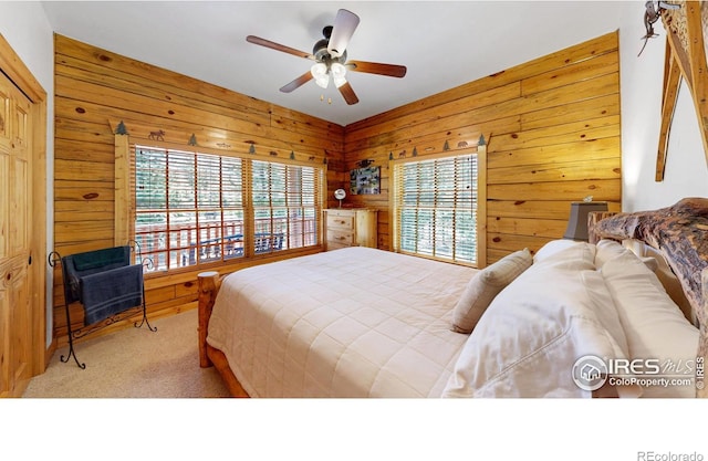 315 County Road 4454, Grand Lake, CO 80447 - carpeted bedroom with multiple windows, wood walls, and ceiling fan