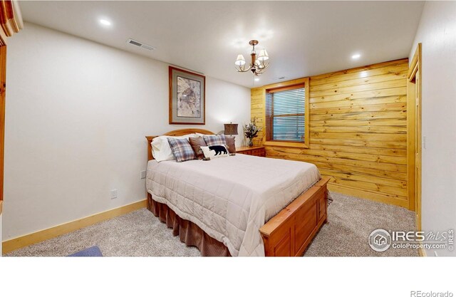 315 County Road 4454, Grand Lake, CO 80447 - carpeted bedroom featuring wood walls, a chandelier, recessed lighting, and baseboards