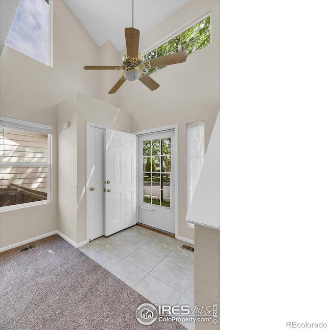 1724 Holeman Dr, Erie, CO 80516 - tiled foyer with high vaulted ceiling, baseboards, and a ceiling fan