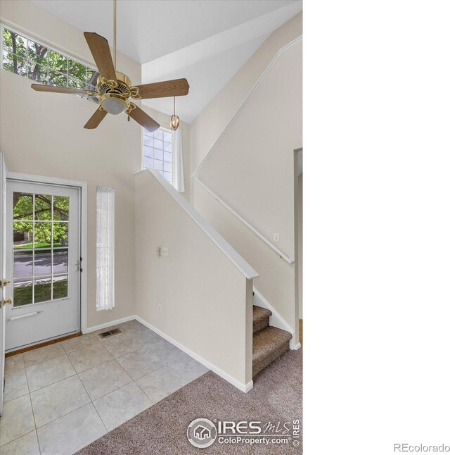 1724 Holeman Dr, Erie, CO 80516 - tiled entrance foyer with plenty of natural light, a ceiling fan, stairway, high vaulted ceiling, and baseboards