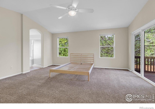 1724 Holeman Dr, Erie, CO 80516 - unfurnished bedroom with carpet floors, access to outside, vaulted ceiling, and baseboards