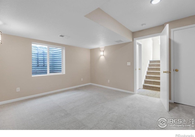 1724 Holeman Dr, Erie, CO 80516 - below grade area with light colored carpet, baseboards, and stairway