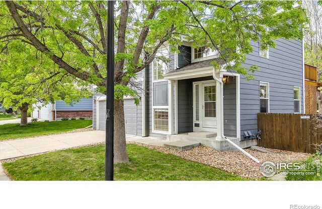 1724 Holeman Dr, Erie, CO 80516 - view of front facade with concrete driveway and an attached garage