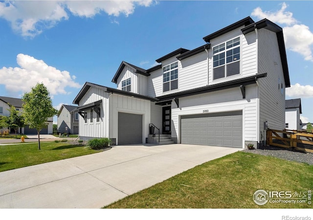 5085 Blanchette St, Timnath, CO 80547 - view of front of home with an attached garage, board and batten siding, and driveway