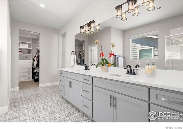 5085 Blanchette St, Timnath, CO 80547 - bathroom featuring double vanity, a chandelier, a spacious closet, baseboards, and recessed lighting