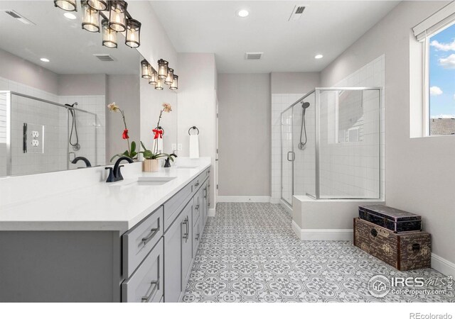5085 Blanchette St, Timnath, CO 80547 - full bathroom with a stall shower, double vanity, baseboards, and recessed lighting
