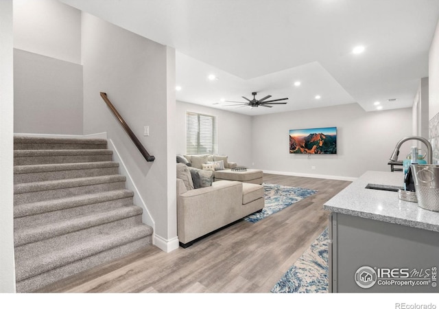 5085 Blanchette St, Timnath, CO 80547 - living area with stairway, baseboards, light wood finished floors, recessed lighting, and a ceiling fan