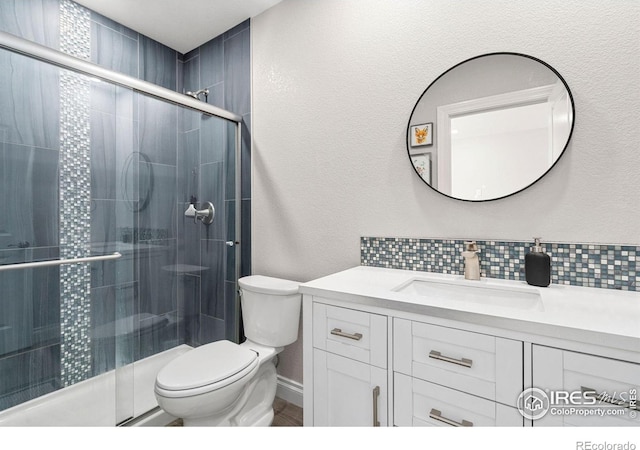 5085 Blanchette St, Timnath, CO 80547 - full bathroom featuring vanity, toilet, backsplash, and a shower stall