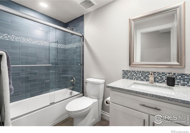 5085 Blanchette St, Timnath, CO 80547 - bathroom featuring vanity, combined bath / shower with glass door, toilet, and wood finished floors