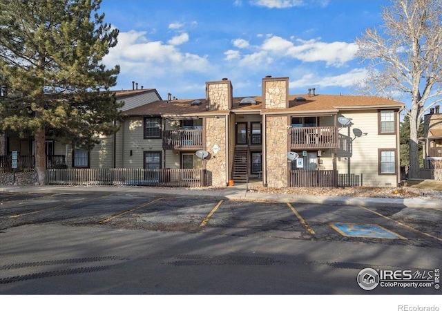 7820 W 87th Dr Unit K, Arvada, CO 80005 - view of property featuring uncovered parking and fence