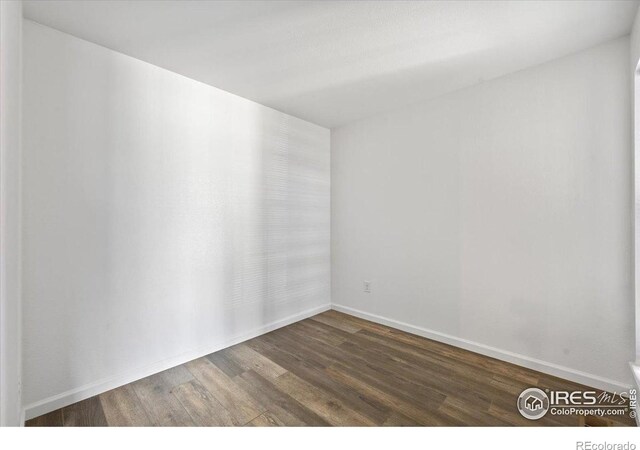 7820 W 87th Dr Unit K, Arvada, CO 80005 - spare room with wood finished floors and baseboards
