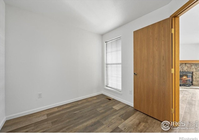7820 W 87th Dr Unit K, Arvada, CO 80005 - unfurnished bedroom featuring wood finished floors, a fireplace, and baseboards