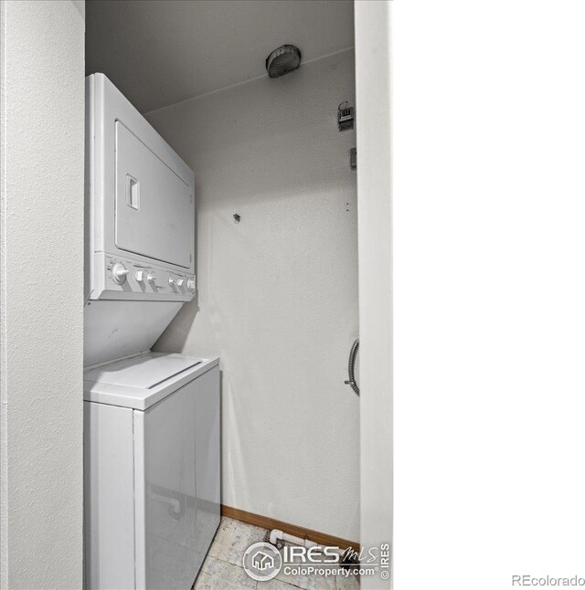7820 W 87th Dr Unit K, Arvada, CO 80005 - washroom with stacked washer and clothes dryer and baseboards