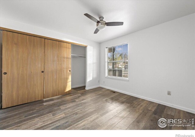 7820 W 87th Dr Unit K, Arvada, CO 80005 - unfurnished bedroom featuring a closet, wood finished floors, baseboards, and ceiling fan