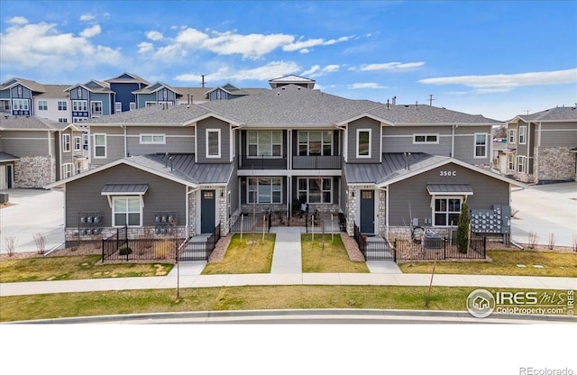 350 High Point Dr Unit 201, Longmont, CO 80504 - multi unit property featuring a residential view, a standing seam roof, and a fenced front yard