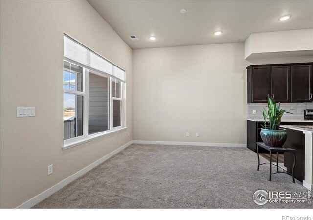 350 High Point Dr Unit 201, Longmont, CO 80504 - kitchen with light colored carpet, light countertops, baseboards, dark brown cabinets, and recessed lighting