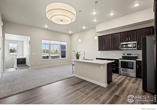 350 High Point Dr Unit 201, Longmont, CO 80504 - kitchen with stainless steel appliances, a sink, open floor plan, plenty of natural light, and recessed lighting