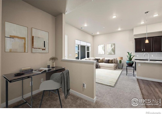 350 High Point Dr Unit 201, Longmont, CO 80504 - home office with baseboards, recessed lighting, a sink, and wood finished floors