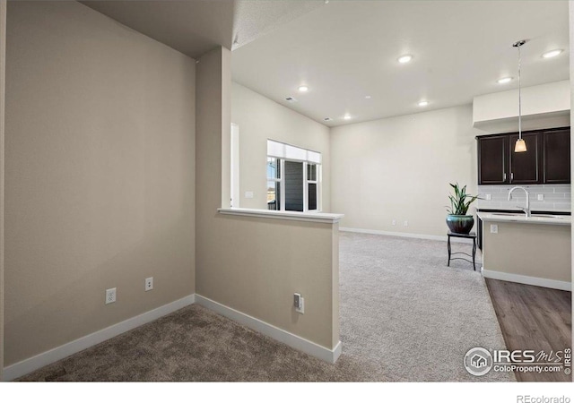 350 High Point Dr Unit 201, Longmont, CO 80504 - kitchen with recessed lighting, baseboards, light countertops, decorative light fixtures, and dark brown cabinetry