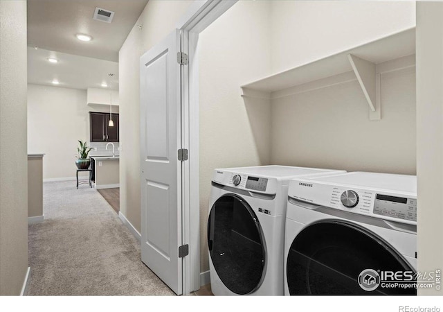 350 High Point Dr Unit 201, Longmont, CO 80504 - washroom with washing machine and dryer, carpet floors, recessed lighting, and baseboards
