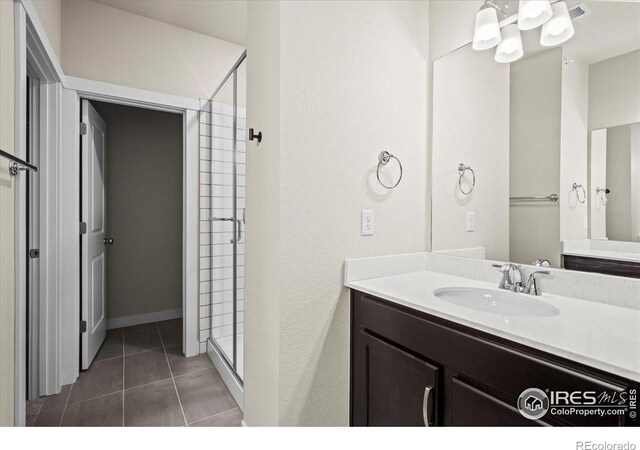 350 High Point Dr Unit 201, Longmont, CO 80504 - full bath with a shower stall, tile patterned floors, and vanity
